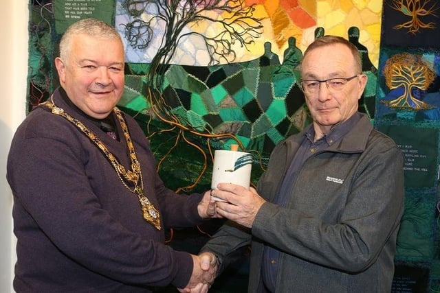 The Mayor of Causeway Coast and Glens Borough Council, Councillor Ivor Wallace, presents John Williams, the overall winner of the Dustbowl photography competition, with his prize, a piece of pottery made by Adam Frew.