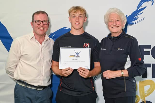 Ulster U19 squad member Clark Logan, who lives near Ballycastle, is pictured receiving his award certificate from Barry Funston and Lady Mary Peters. Credit: Mary Peters Trust