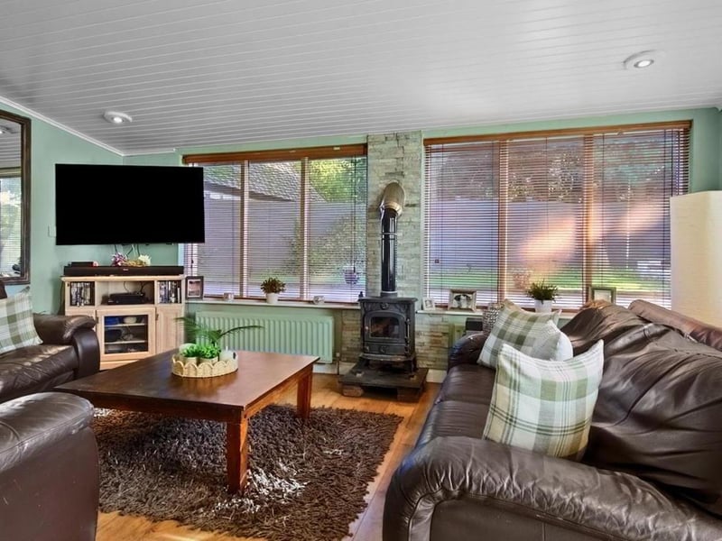 Family room with open arch to kitchen and glass panelled French doors leading to conservatory.