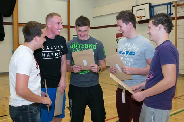 Brian McQuillan, Stuart McFall, Dan Campbell, Timmy Livingstone and Gareth Lunn open up their A-Level results at Ulidia Integrated College in 2013. INCT 34-416-RM  Photo: Ronnie Moore