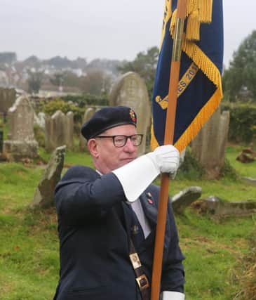 Standard bearer Eric Wilson at Remembrance Sunday at the war graves at Bonamargy Friary.