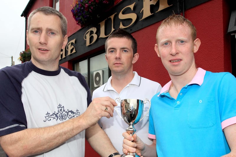 Sponsor Craig Black of The Bush Tavern presents the Bush Tavern Summer Cup to Captain of Glebe Rangers Reserve Kirk Bruce. Included is organiser of the competition Ricky Mooney pictured back in 2009