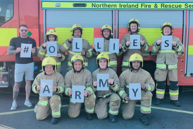 Ollie's dad, Justin with firefighters showing their support for 'Ollie's Army'.  A group from Carrickfergus Fire Station will tackle the ‘Storming the Castle’ road race this summer - all while wearing their fire kit.