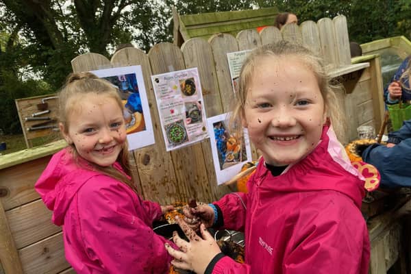 Sophie Gardiner and Pippa Gaston making some acorn crumble in the mud kitchen.
