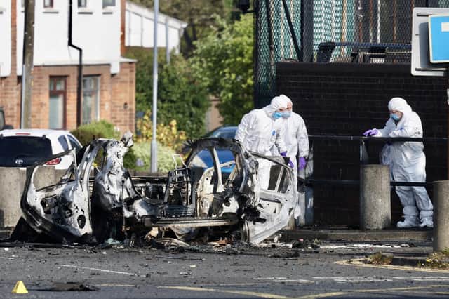 Forensic teams at the scene of the security alert outside Dunmurry police station. Picture: Andrew McCarroll / Pacemaker