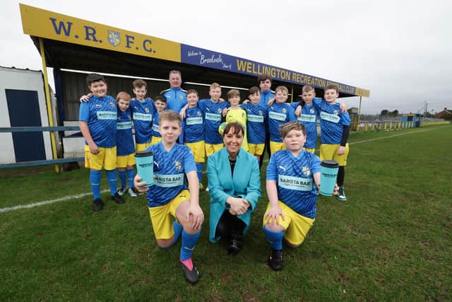 Keavy O’Mahony-Truesdale from Barista Bar is pictured with Wellington Rec FC Under 12s. (Picture: Press Eye).