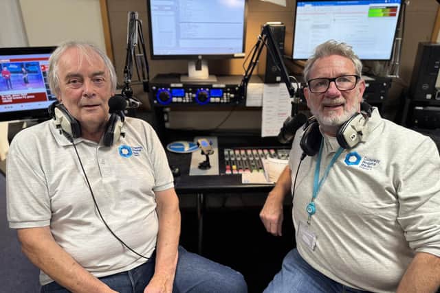 Causeway Hospital Radio volunteers Mervyn Nicholl and Richard Brown behind the desk in the broadcasting studio.