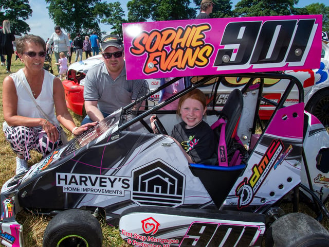 Ninja Kart racer, Sophie Evans shows off her kart at the vehicle section of the Drumcree Parish Garden Fete. Also included are her gran, Shirley Tedford and dad, David Evans. PT23-235.