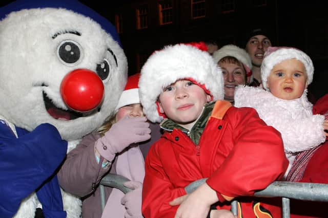 Barry, Annie and Louise pictured with a snowman in Garvagh during the Christmas lights switch on