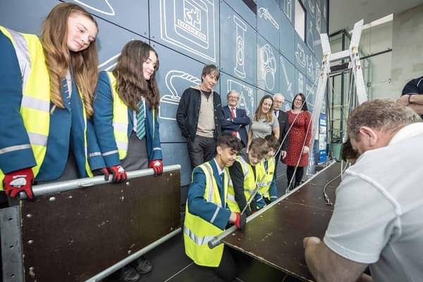 Professor Brian Cox CBE FRS with pupils during the event at The Braid.