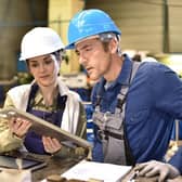 Metallurgy workers in the workshop using digital tablet.