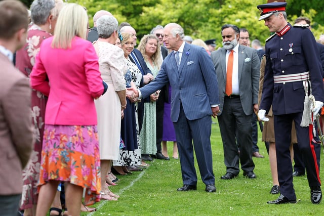 King Charles meeting guests at the royal garden party.