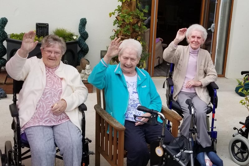 Residents waving to visitors during the fundraiser at Knockagh Rise.