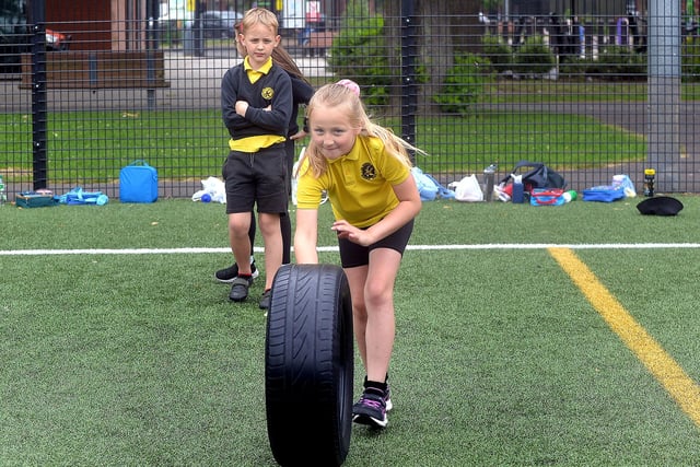 This Hart Memorial Primary School pupil enjoying the tyre rolling exercise at the Shared Education Fun Day. PT24-207.