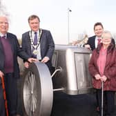 A commemorative racing car sculpture was unveiled in Ballyrobert in 2014 as a lasting legacy to the English Racing Automobiles racing car that won the first international road race in Britain after the Second World War in 1946. Then Mayor, Ald Fraser Agnew, is pictured with Mr and Mrs David Beattie from the village and Ald Mark Cosgrove. (Pic: Freddie Parkinson).