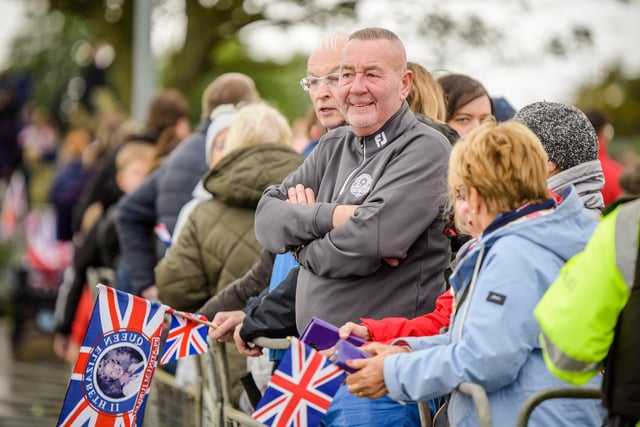 A section of the crowd waiting for the Prince and Princess of Wales to come by.