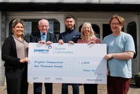 SCUG representatives receive a £1,000 donation from Power NI representative Barry Rogan (centre).