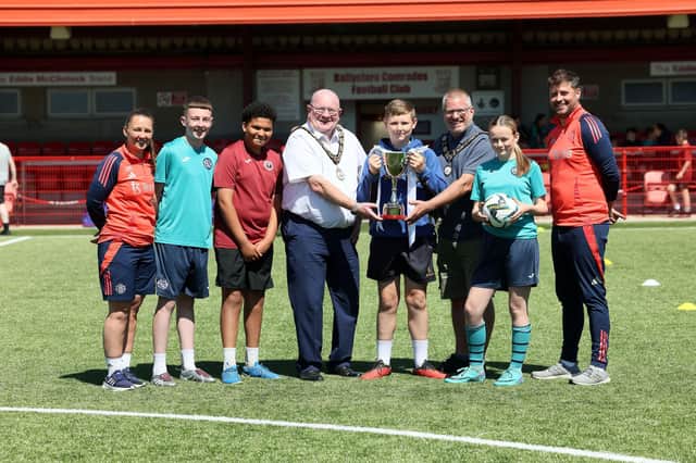 The Mayor of Antrim and Newtownabbey, Councillor Neil Kelly, and Deputy Mayor, Councillor Paul Dunlop BEM, are pictured at the Budget Energy SuperCupNI Ballyclare May Fair Festival of Football, alongside coaches from the Manchester United Girls’ Academy and Ballyclare Comrades Ladies