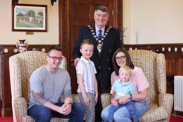 Lewis Rennie (6) and his family at the Mayor's parlour with Alderman Noel Williams.