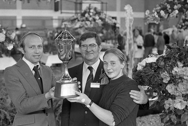 Pictured in September 1982 holding the Ransome Trophy for floral design which they won at Ayr are members of the Belfast Parks Department who made a fountain the centrepiece of their display in the City of Belfast Flower Show at Maysfield Leisure Centre. They are, Mr Craig Wallace, director of parks, centre, Mr Reggie Maxwell, area manager and leader of the parks display team and gardener Angela McDowell