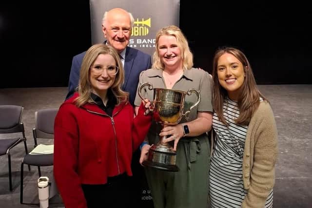 L-R Rachel Gilpin, Jessie Weir and Lucy Sterritt accepting award from Brass Band Northern Ireland President Mr Bill Caughey.