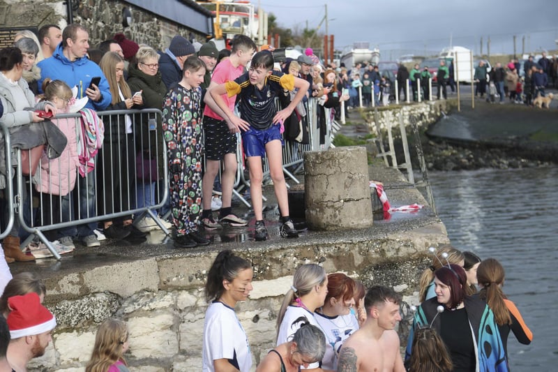 Crowds gathered for the annual charity swim at Carnlough harbour.