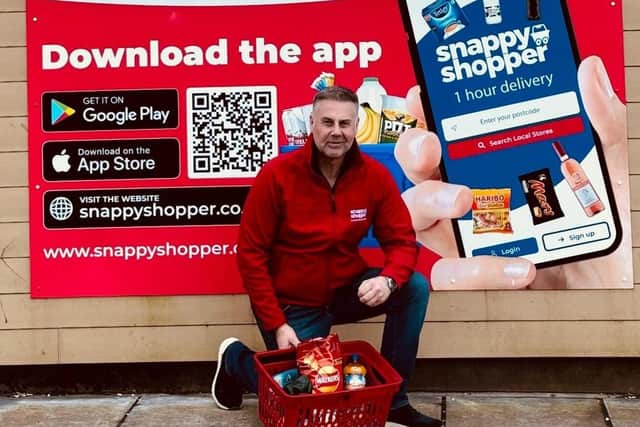 Malcolm Hall, who owns Vivo@FoodHalls Drumgor in Craigavon, with the special one-day basket of groceries. Picture: Snappy Shopper.