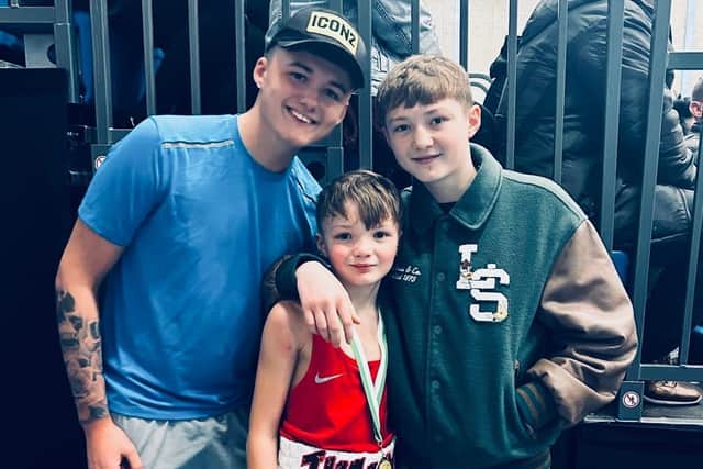 Young Larne boxer James Hassin (11) with his brothers Jack and Harry, who is also a boxer.  Photo: supplied
