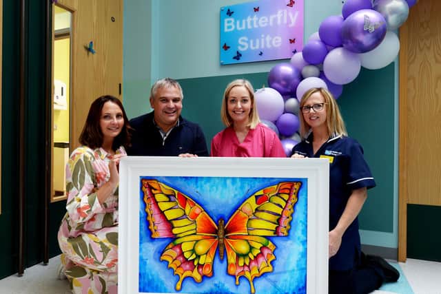 This lovely piece of artwork called ‘Butterfly Niamh’ was created by Ella Hamilton and donated to the Butterfly Suite in Memory of Baby Niamh Armitage. Niamh’s parents are
pictured with the artwork alongside Nicola-Ann Henderson (Consultant) and Mary Dawson (Lead Midwife). Photo courtesy of Southern Health Trust