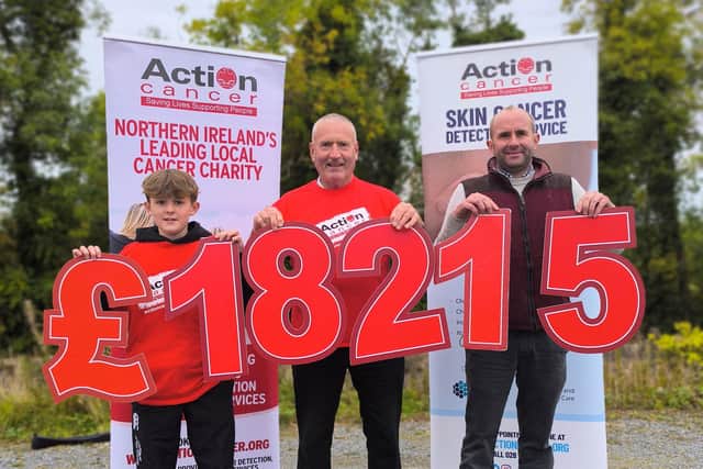 13-year-old Harry Heron, Raffrey farmer Dee Heron and Saintfield Mart auctioneer Geoffrey Murphy together raised £18,215 for Action Cancer. Pic credit: Action Cancer