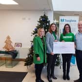 Topglass’ Cathy Loughlin, Joanne Etherson and Mark Mitchell present funds raised last year to local Macmillan representative Joanne Young.