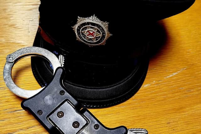PSNI officer's hat and handcuffs.