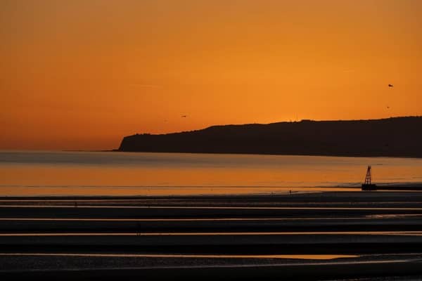 The sun sets over Camber Sands.