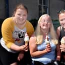 Treating themselves to ice cream cones during the heat wave on Wednesday afternoon are from left, Amy-Louise Abraham, Lucy Cloughan and Tanya Mathett. PT22-248.