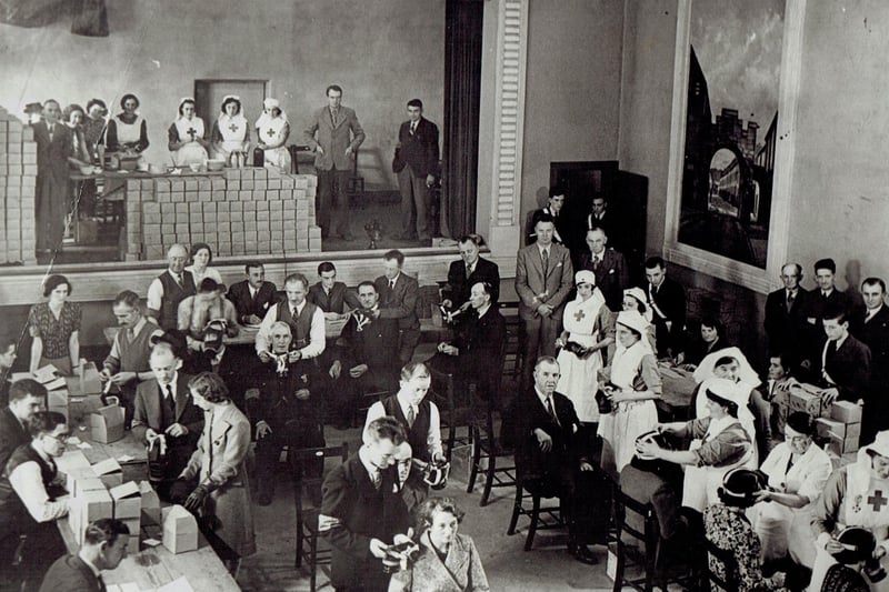 Distribution of gas masks by the Red Cross in Carrickfergus Town Hall, 1939. Gas attacks were considered a very real threat in 1939, and the Government decided that gas masks should be issued to every man, woman and child. Some 38 million masks were needed for the civilian population and were distributed throughout the UK in small cardboard boxes.