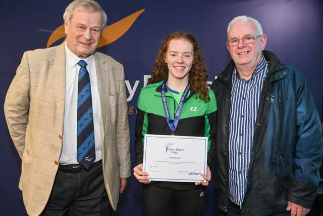 Lisburn badminton player Paige Woods has received a Mary Peters Trust athlete award. Paige is pictured with her dad Trevor Woods (right) also a badminton champion and Ken Nixon (left) a Mary Peters Trust Board Director and Ulster Badminton, Badminton Ireland and GB Badminton Board member.