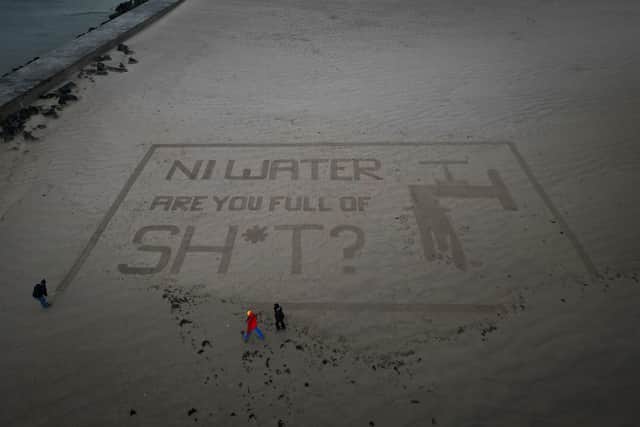 Act Now's sand art stunt targeting NI Water at Castlerock Beach last Saturday