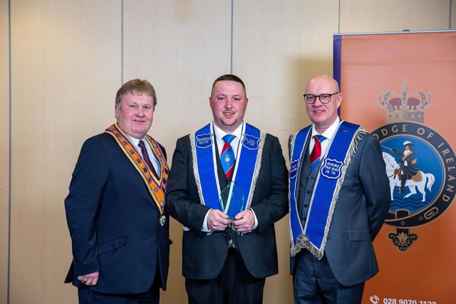 Deputy Grand Master Harold Henning presents the Lodge Numerical Increase Award to Worshipful Master Simon McIlreavy and Secretary Bro. David Steen of Invincibles True Blues LOL 735, Coleraine District LOL No. 2. Pic by Graham Baalham-Curry