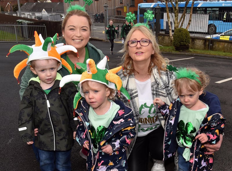 Sporting seasonal headgear at the Derrymacash St Patrick's Day celebrations are from left Aodhan Mulholland (3) and twins Aleena and Fiadh (2) Mulholland. Also included are adults, Jacqueline Kane, left, and Melissa Maginn. LM12-228.