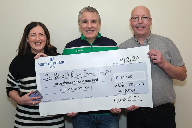 Seamus Scullion (centre), principal St. Patrick’s Primary School is presented with a cheque for £3,151 from Nuala Mitchell, secretary Loup CCE and chairman Jim Gallagher.
