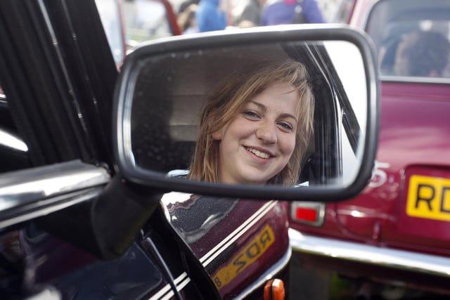 Cathy Graham looks in the wing mirror of her mini during the Causeway Coast Mini Festival at the Dunluce Centre Portrush in 2010.