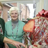 Joan McCaffrey (left), organiser of a Coffee Morning in Shiels Court in 2009 in aid of Ballymoney Hospice Support Group, pictured along with Group treasurer, Annie McFarland and a Valentine's  hamper which was up for grabs in a raffle.