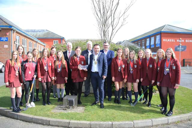 Under 16 Captain Katie Niblock accepts the inscribed crystal Bowl from Council Chairperson Councillor Pete Byrne, Councillors Henry Reilly and Glyn Hanna and Conor Haughey Assistants Director Healthy Living and the U16 Hockey Team now Ulster Champions.