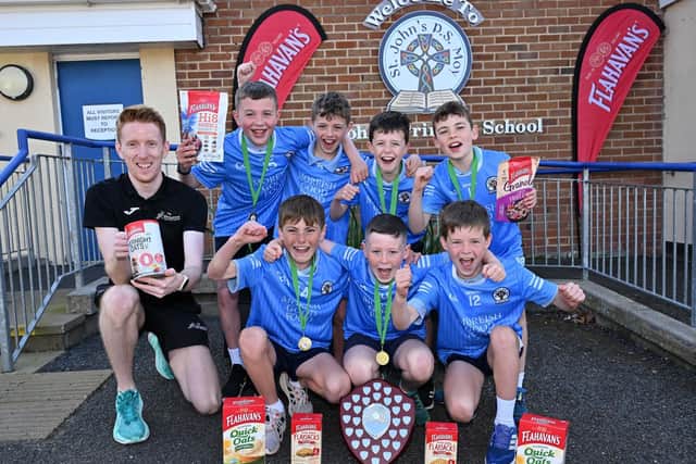 Local pupils from St John’s Primary School, Moy, celebrating their victory at the Flahavan’s Athletics NI prize giving ceremony, receiving their award from Athletics NI Coach, Luke Dinsmore.
