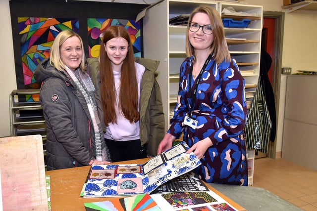 Head of Art and Design at Craigavon Senior High School, Mrs Lauren Wethers shows some examples of student's work to prospective pupil, Scarlett Watt and mum, Emma during the school open night on Thursday. PT04-208.