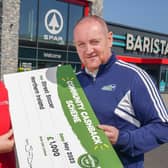 Stephen Fleming from Street Soccer NI is pictured with Bronagh Luke from SPAR NI to receive a cheque for £1,000 as part of SPAR’s Community Cashback Grant Funding for 2023.