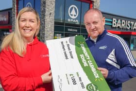 Stephen Fleming from Street Soccer NI is pictured with Bronagh Luke from SPAR NI to receive a cheque for £1,000 as part of SPAR’s Community Cashback Grant Funding for 2023.