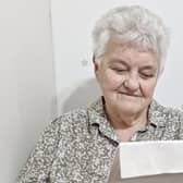 Coleraine woman Margaret Peacock reading her letter of congratulations from King Charles III. CREDIT ALANA LITTLEJOHN