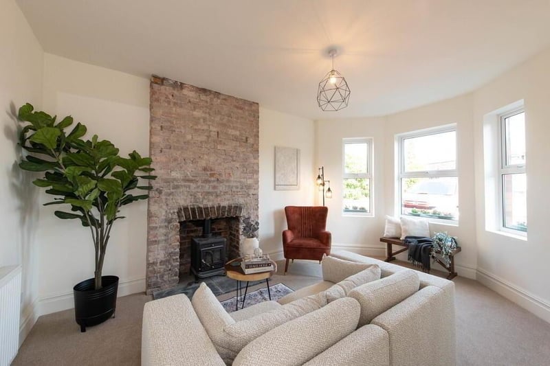 Drawing room with distressed brick fireplace.