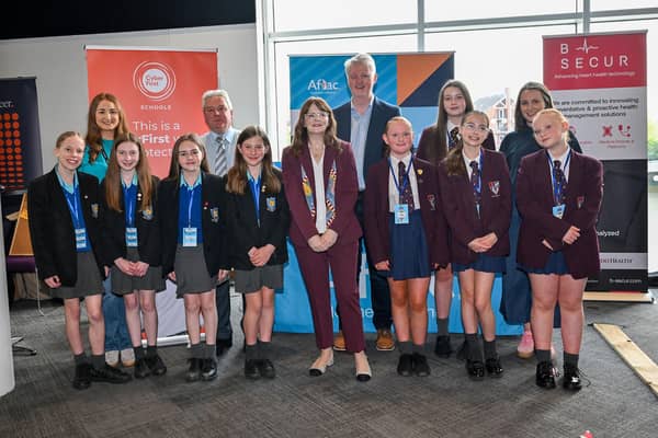 (L-R) Victoria Logan, Cyber Security Communications Delivery Lead, Aflac Northern Ireland, Eamonn Brankin, CyberFirst NI Regional Lead, Mark McCormack, Managing Director, Aflac Northern Ireland, Dr Caoimhe Archibald MLA and Sara Lyons, CyberFirst NI Project Manager alongside students from Ballycastle High School and Foyle College.